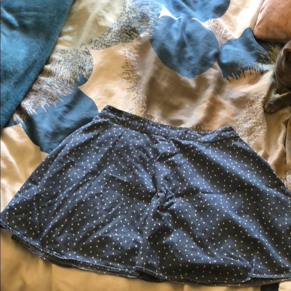 A high waisted blue polka-dotted skirt